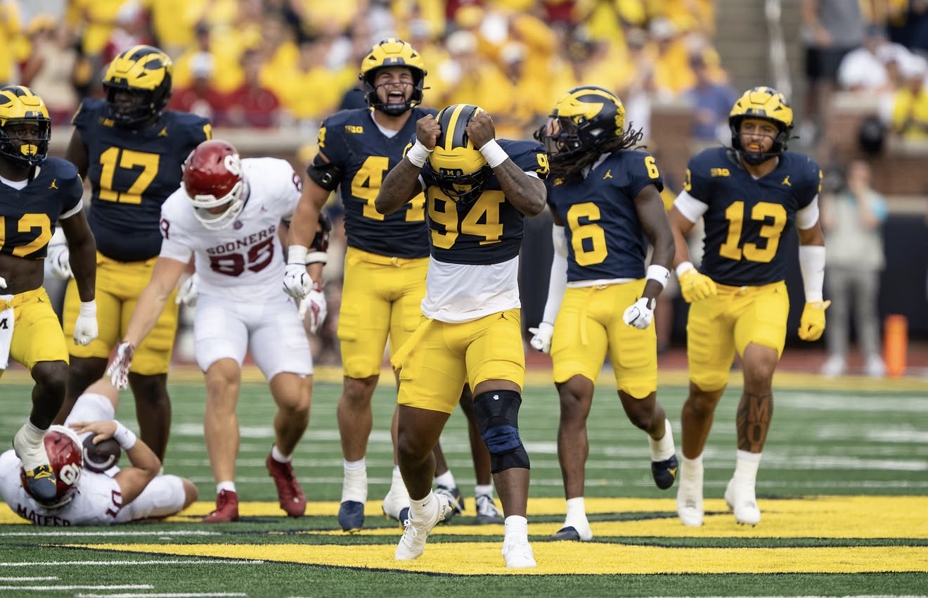 Nate Marshall celebrating on the field with Michigan teammates