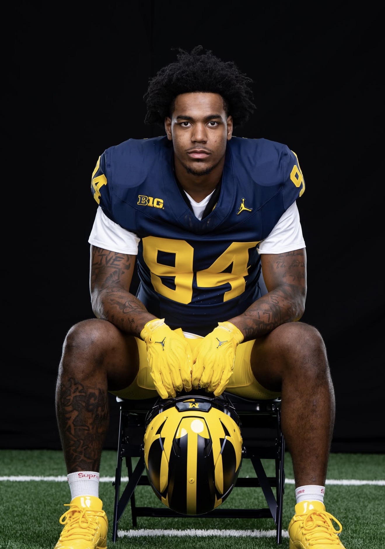 Nate Marshall seated in his Michigan number 94 uniform