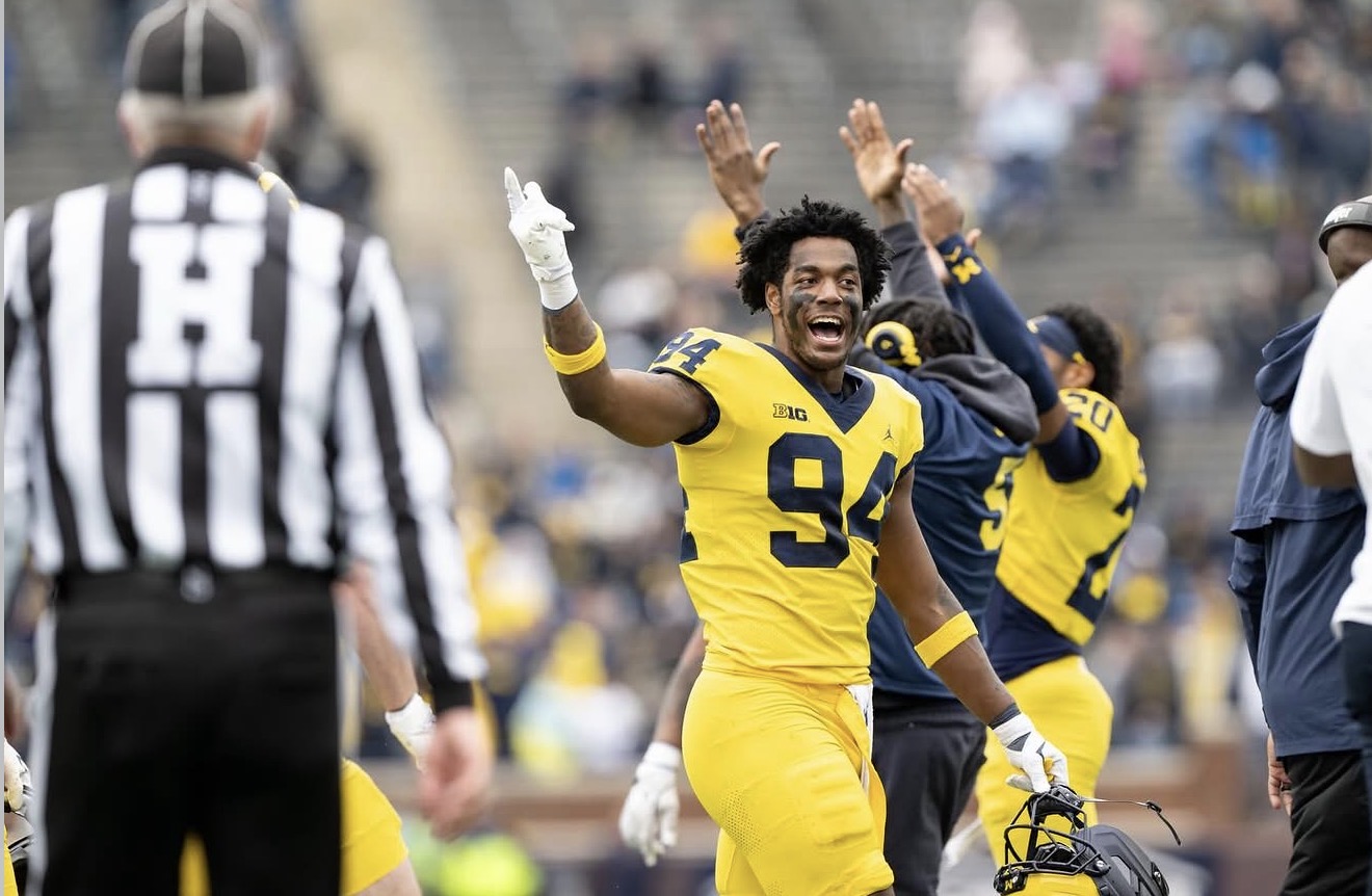 Nate Marshall smiling on the Michigan sideline