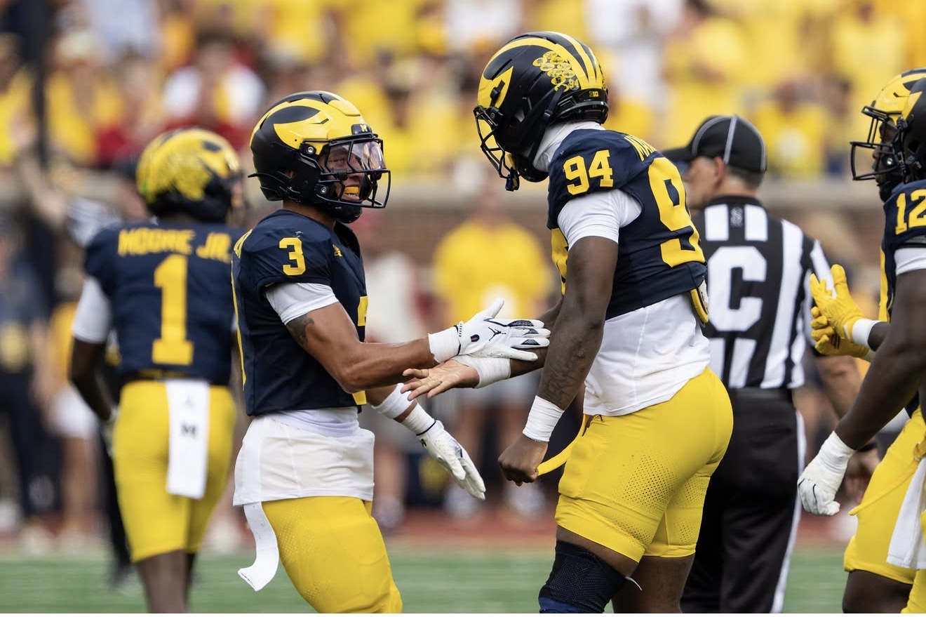 Nate Marshall interacting with a Michigan teammate
